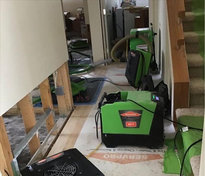 A water damaged hallway with SERVPRO drying equipment in place 