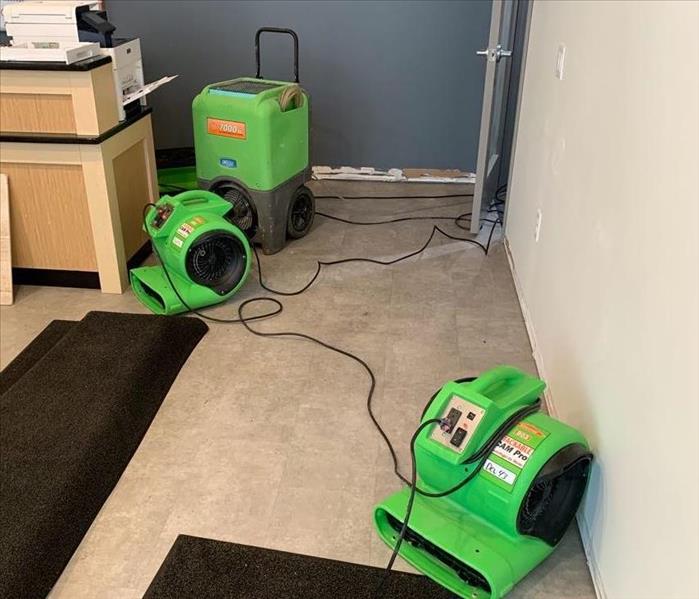 a commercial business in fitchburg, wi with green servpro drying equipment 