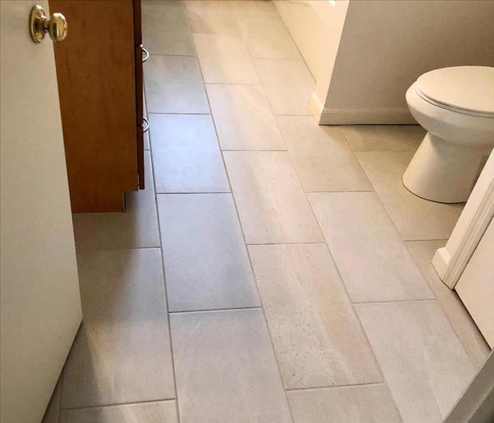 a bathroom remodeled with new tile and drywall after a water loss