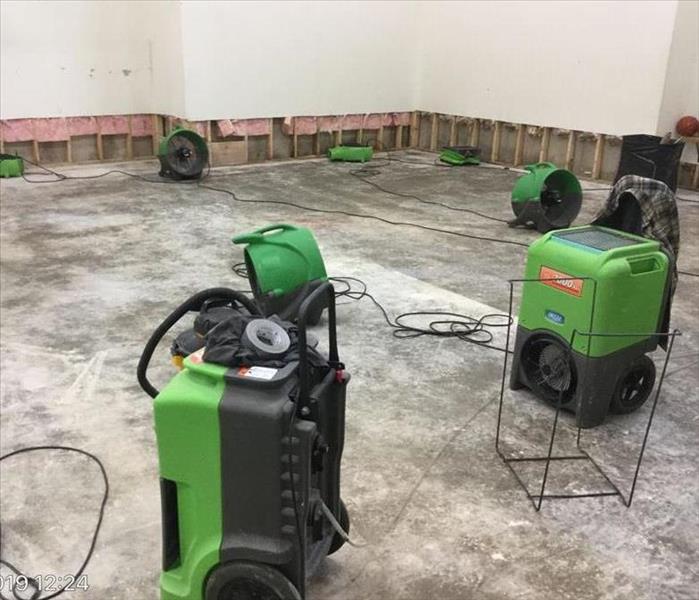 sport court with flooring removed and flood-cut after because of extreme flood damage - industrial air movers and humidifiers