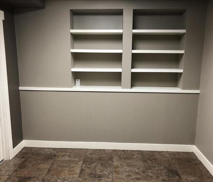 Newly remodeled basement built-in cabinets with freshly painted grey walls & white trim 