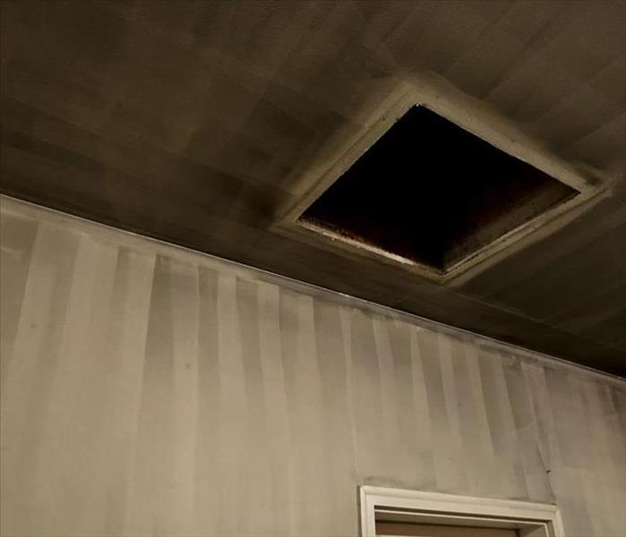 ceiling of garage fire in the initial stages of soot wipe down